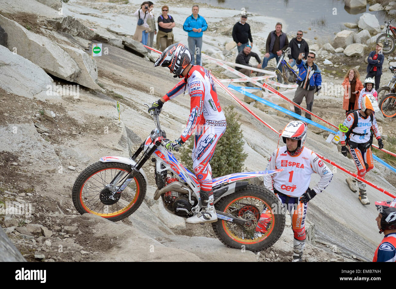 Spain trial championship. Unknown people are looking at Jeroni Fajardo when he drives a Beta motorcycle over granite rocks. Stock Photo