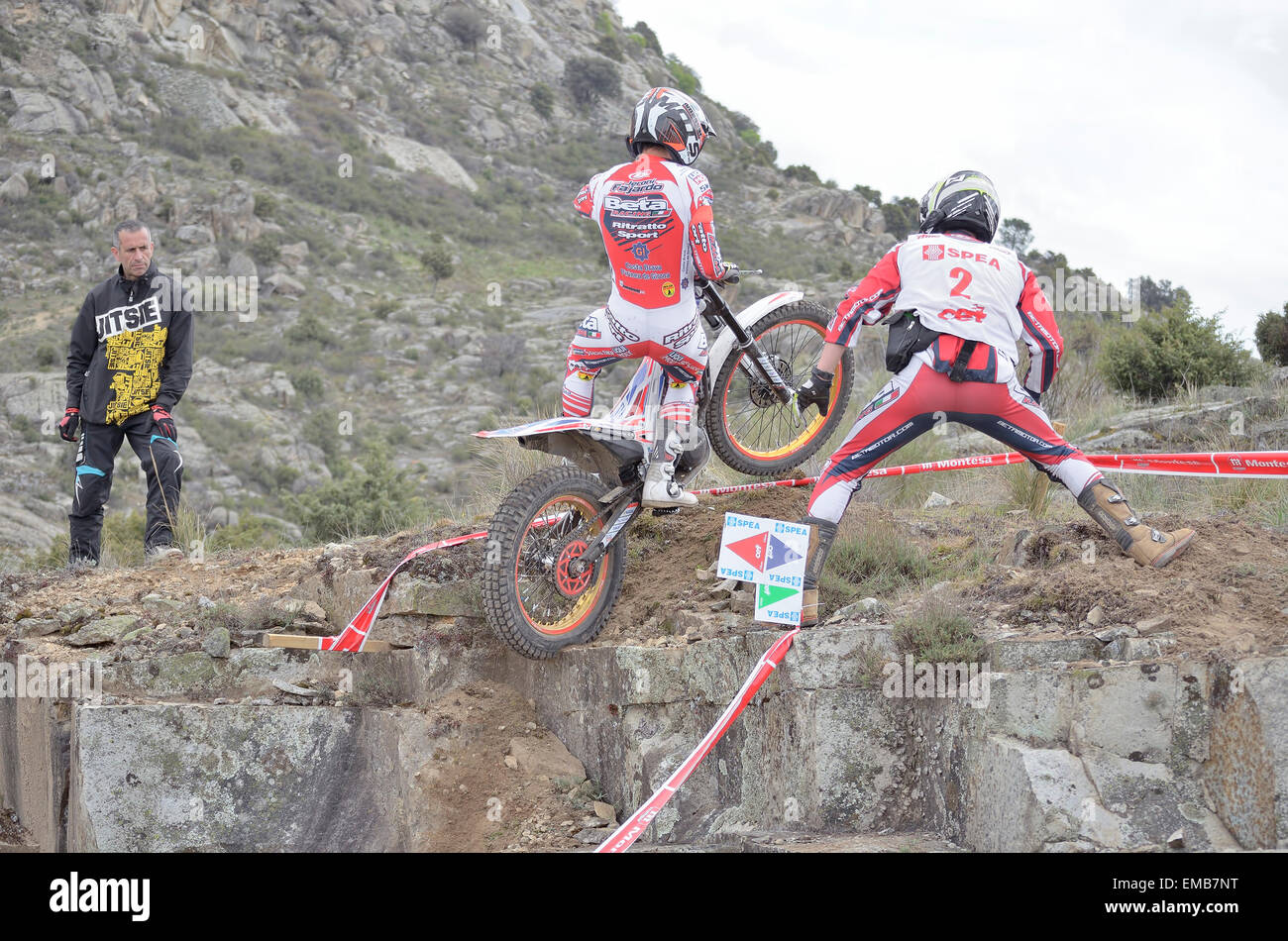 Spain trial championship.Unknown people are looking at Jeroni Fajardo,when he is jumping over granite rocks. (2nd position TR1) Stock Photo
