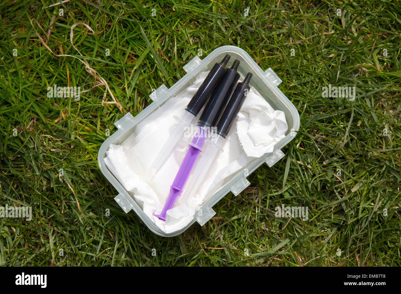 Manchester, UK 19th April, 2015. 'Simpson oil ' held by certain Cannabis festival-goers at Platt Fields Park. This ‘420’ event is advertised as a mini-festival for people, weed smokers, who support the legalisation of cannabis. Police officers warned they would take a dim view of anyone taking drugs at this year’s Puff-Puff-Pass Day event. Greater Manchester Police and have had to issue a number of verbal warnings to people doing so. Stock Photo