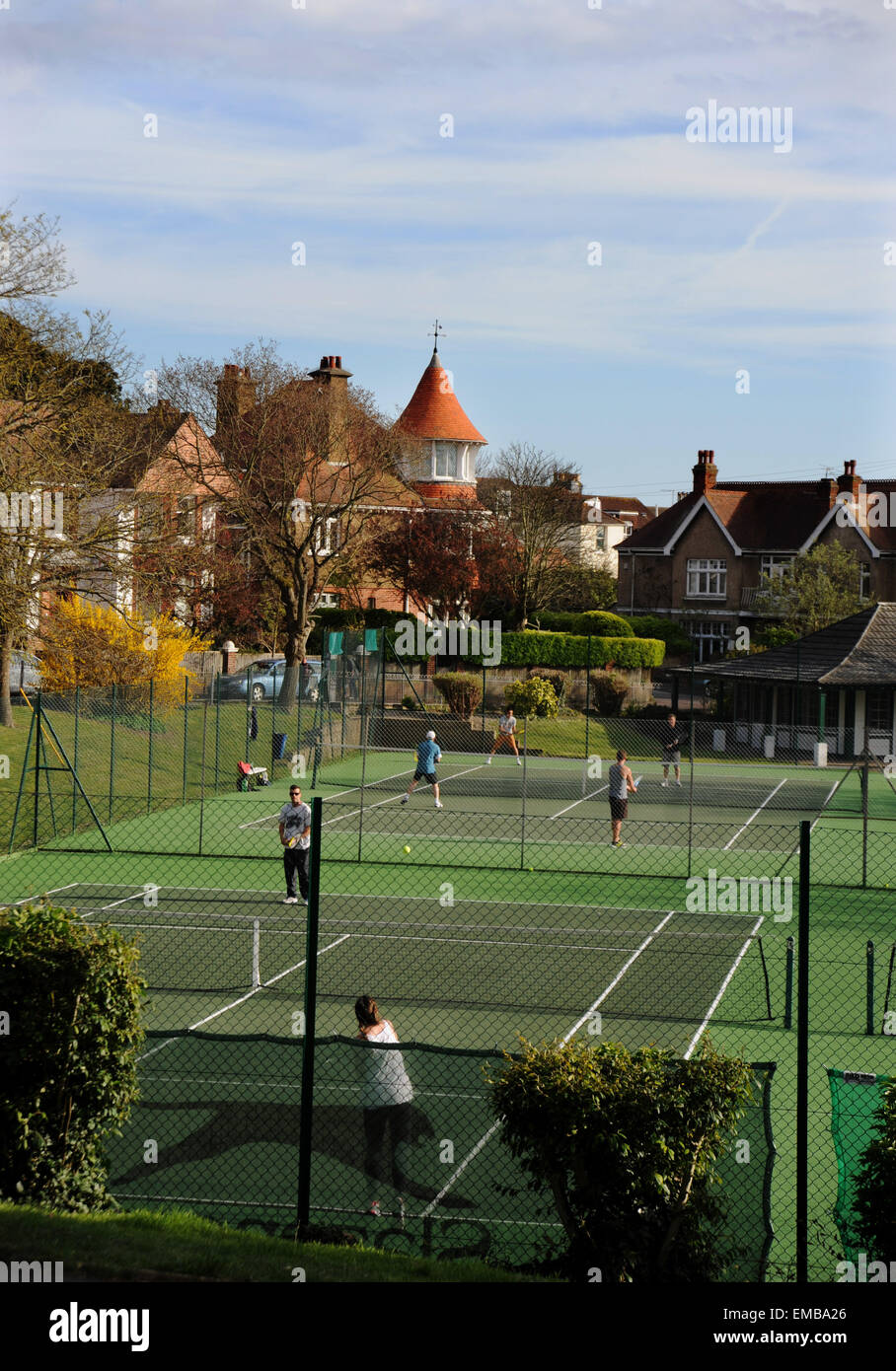 Brighton Sussex UK 19th April 2015 - Tennis players enjoy the lovely weather on the Queens Park courts in Brighton this afternoon Photograph taken by Simon Dack/Alamy Live News Stock Photo