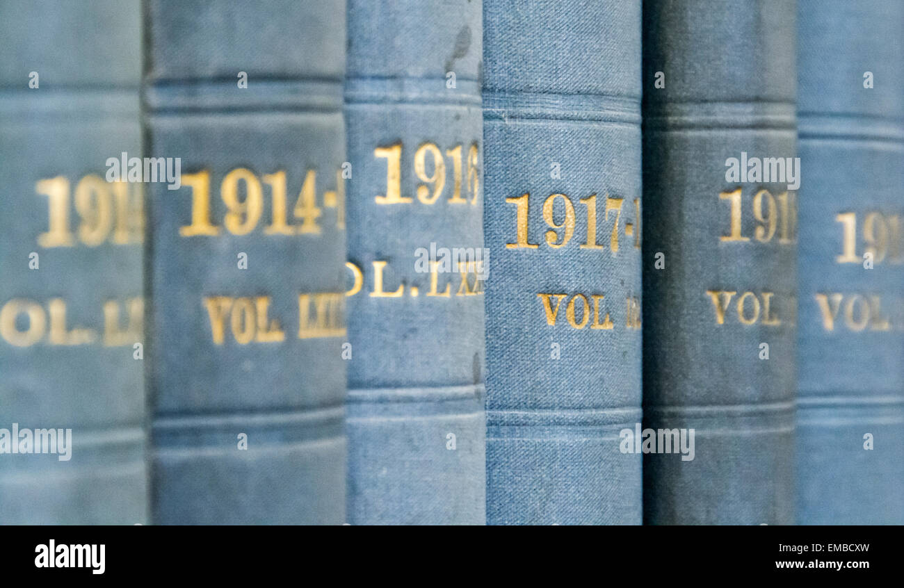 Pale blue books, volumes in a series of Hansard, on a shelf in the central library of the city of Bristol. Stock Photo