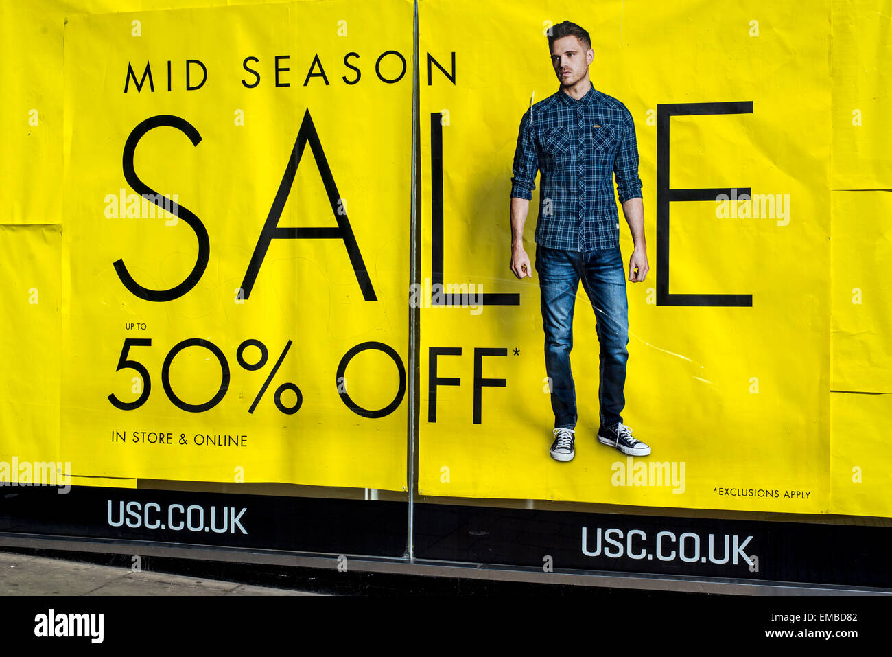 Mid season sale poster with 50% off at the USC clothing store on Princes Street, Edinburgh, Scotland, UK. Stock Photo