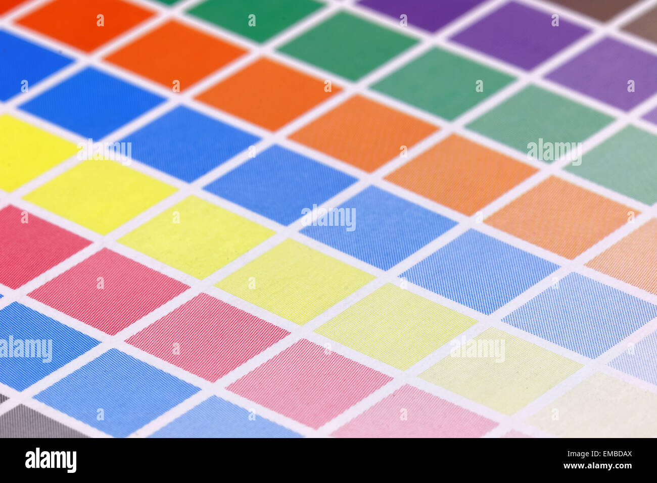 Close-up of a a cmyk test print with many color squares. Side view, very short depth of focus Stock Photo