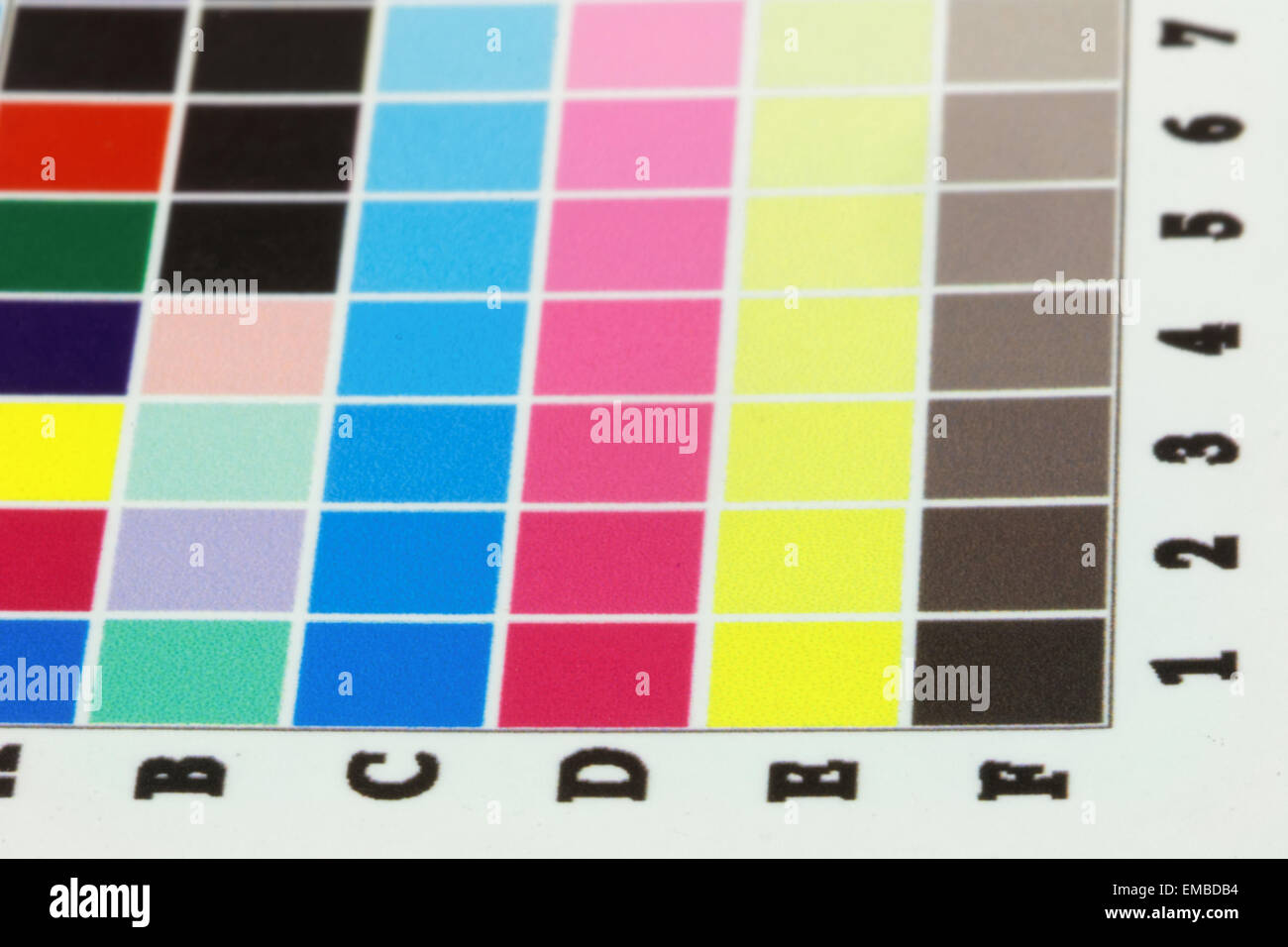 Close-up of a a blurry inkjet cmyk test print with many color squares. Side view, short depth of focus Stock Photo
