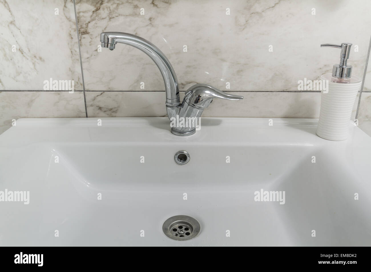 Clean modern bathroom chrome faucet on white Stock Photo Alamy