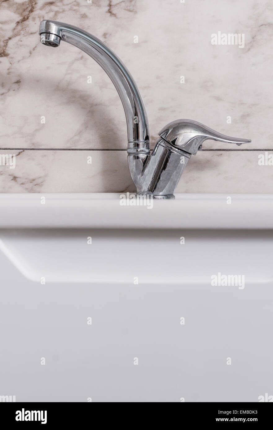 Clean Modern Bathroom Chrome Faucet On White Cabinet Stock Photo