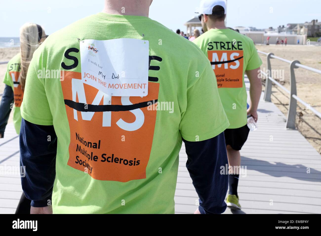 Participant in National MS Walk 2015 wearing a tag saying 'I walk for my Dad' Stock Photo