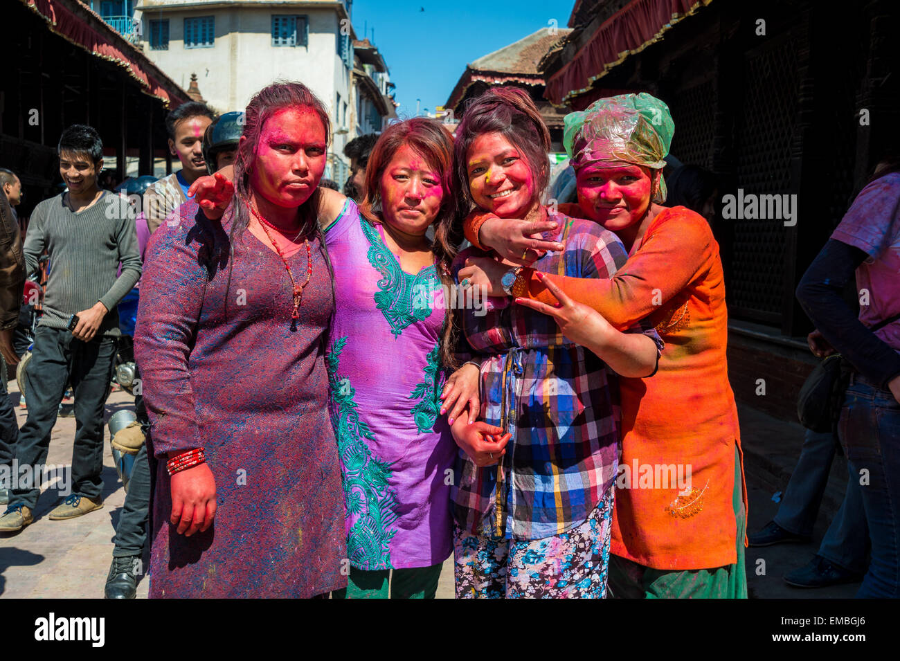 Four young girls with paint on the face are celebrating Holi Festival in Kathmandu, March 2015. Stock Photo