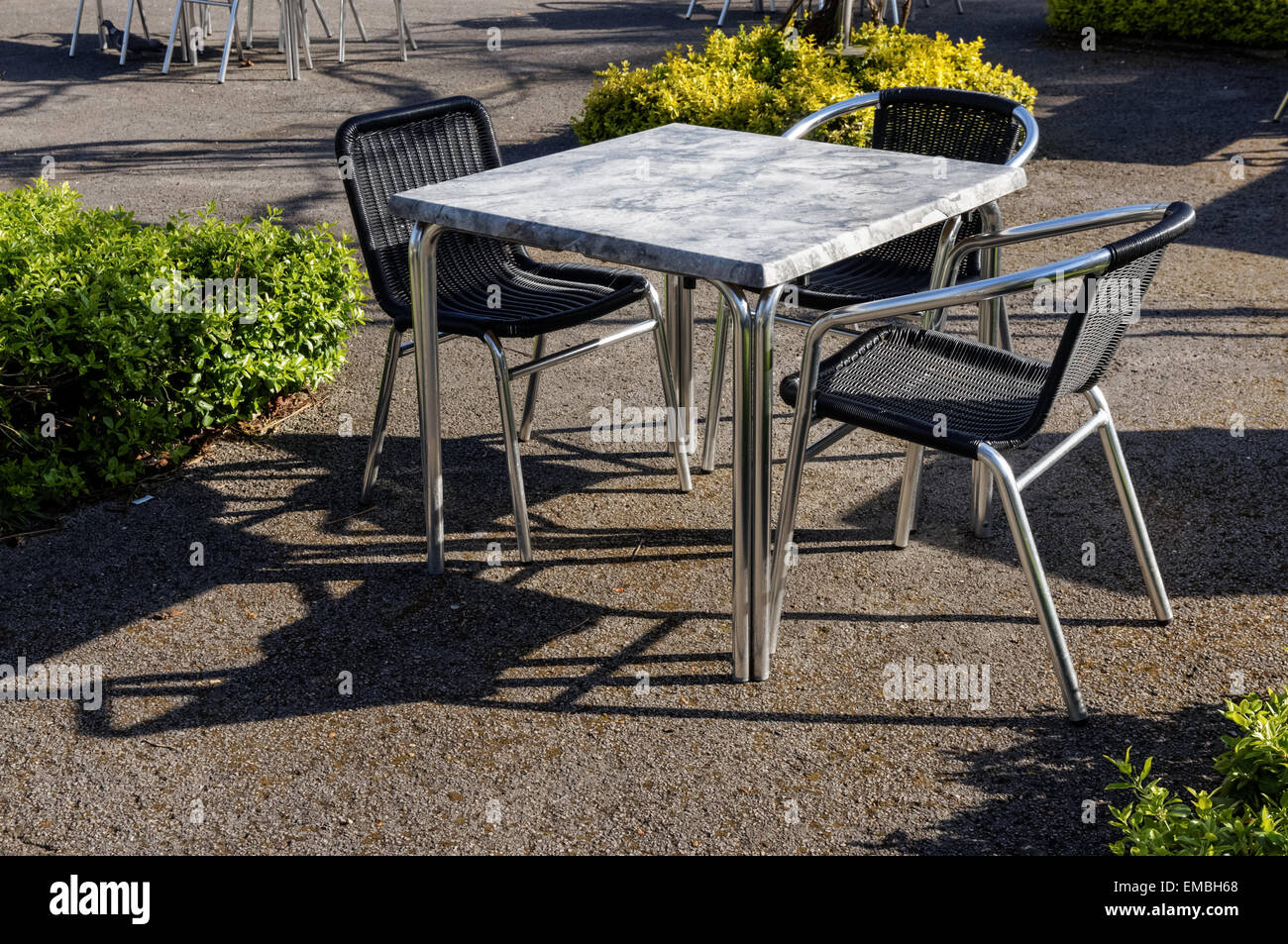 Empty table and chairs outside cafe restaurant Stock Photo