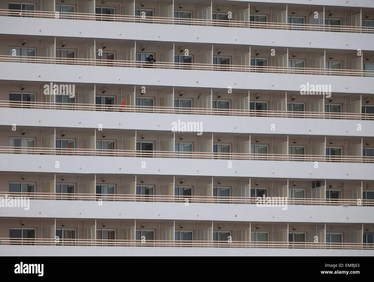 Lonely man standing and looking on a hotel balcony Stock Photo - Alamy