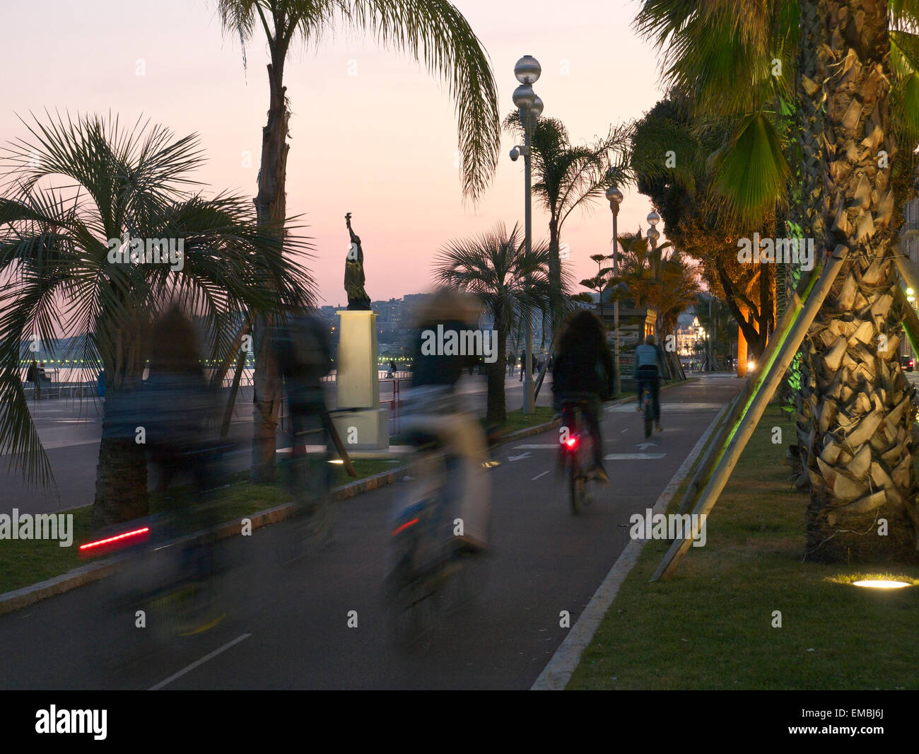 Cyclists on a cycle lane next to Nice promenade Stock Photo