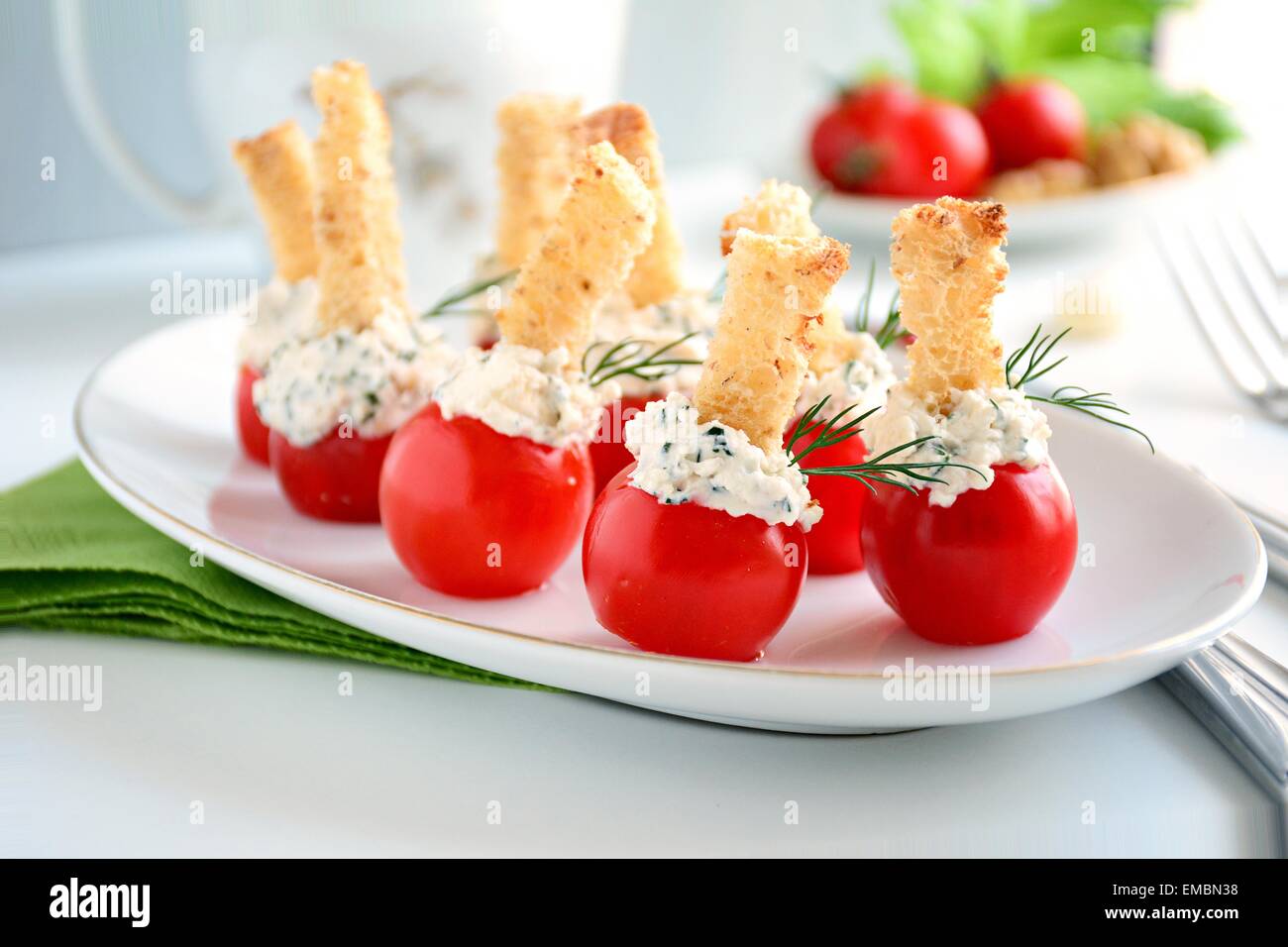 Gourmet appetizer stuffed cherry tomatoes with cream cheese, herbs and