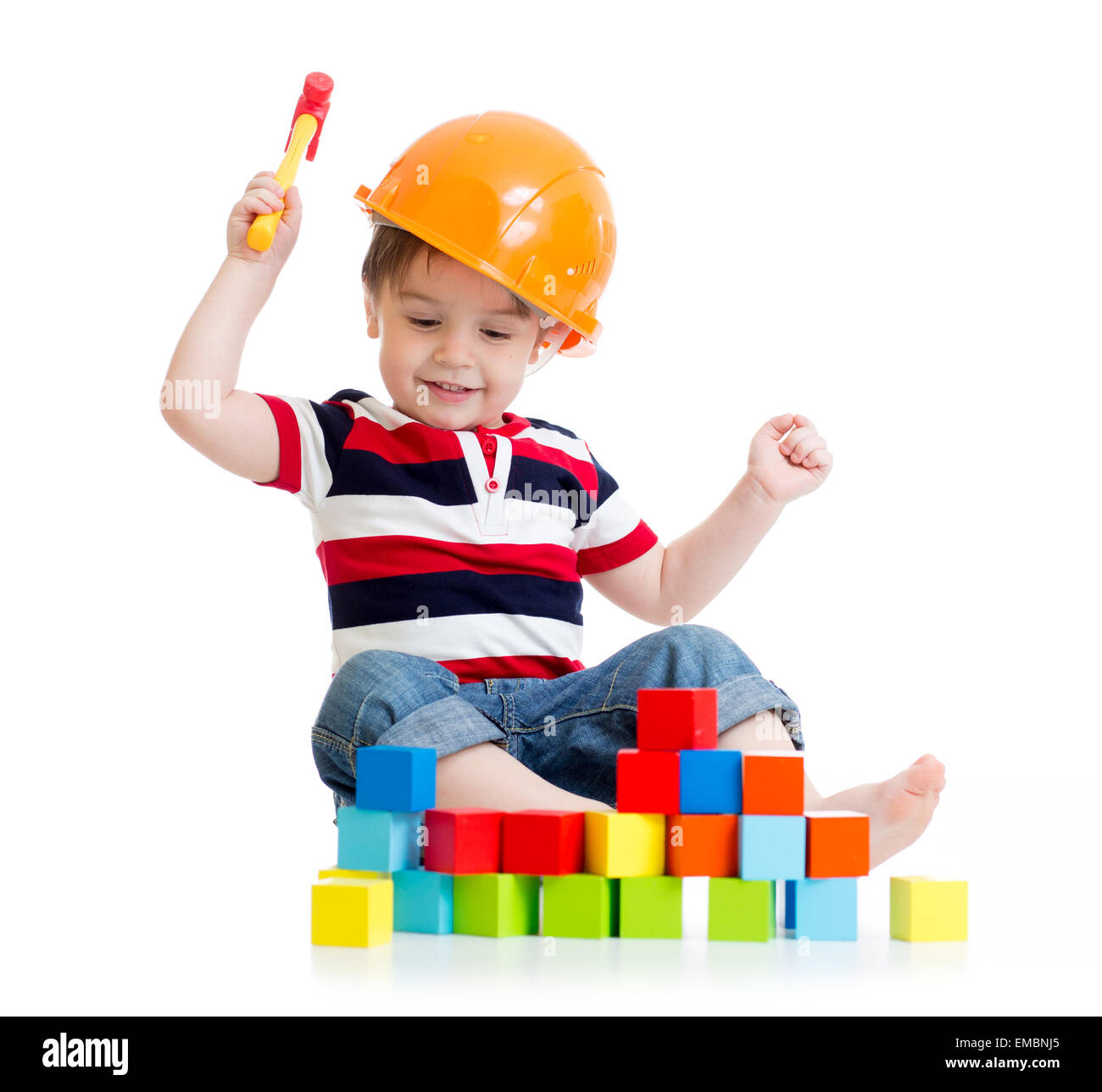 smiling child with hard hat and toy hammer Stock Photo