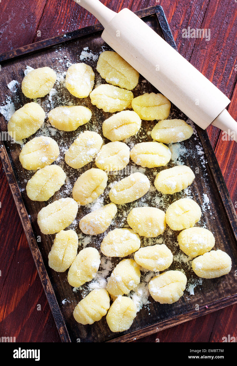 gnocchi from potato on wooden tray and on a table Stock Photo