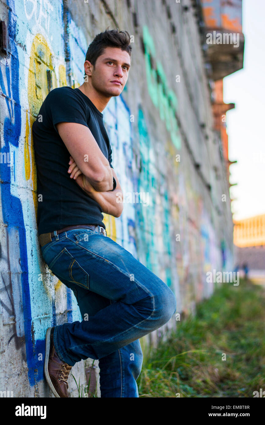 Young black man standing wall hi-res stock photography and images - Alamy