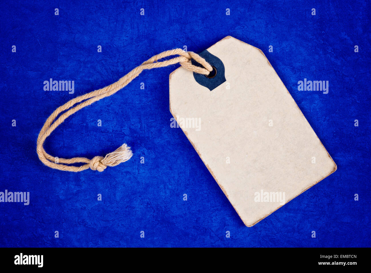 Blank Discount Vintage Price Tag Label as Copy Space on Blue Grunge