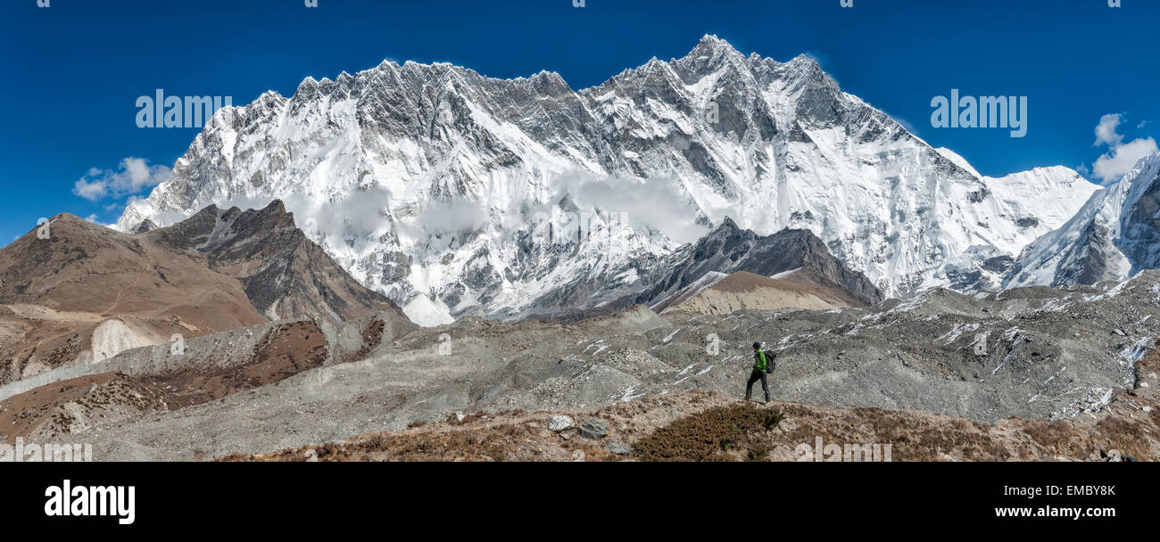Nepal, Khumbu, Everest region, trekker near Dingboche, Lhotse and Nuptse in background Stock Photo