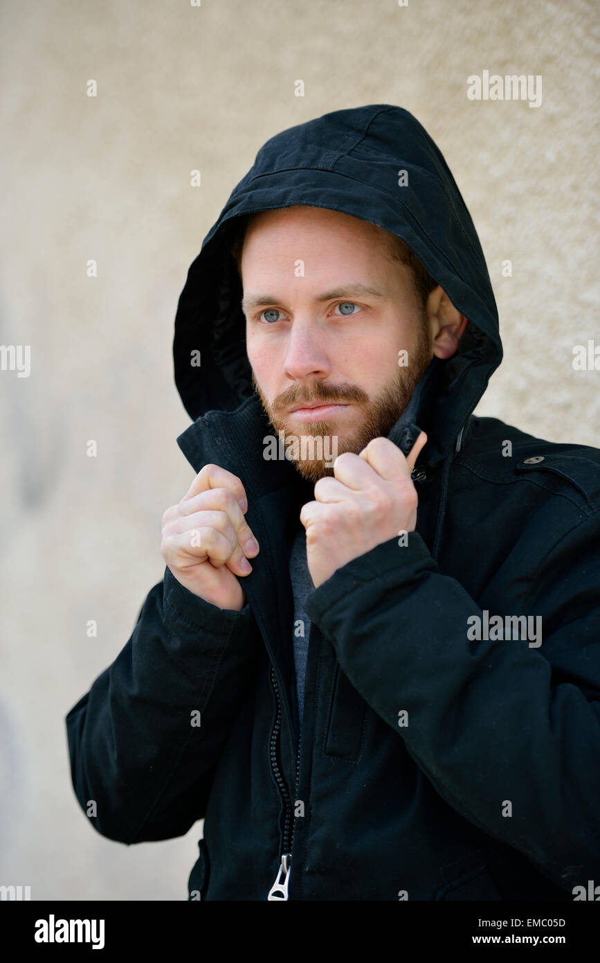 Young man beard pulling hood hi-res stock photography and images - Alamy