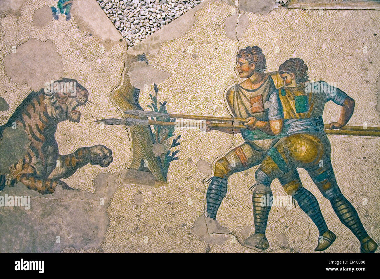 Ancient Mosaic in Great Palace Mosaic Museum in Istanbul, Turkey. Soldiers with spears fighting a tiger Stock Photo