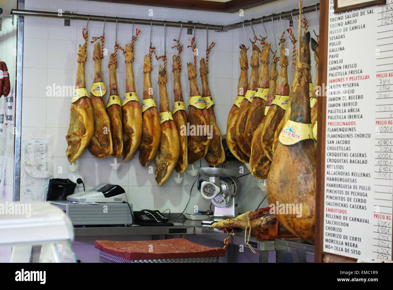 Legs of cured ham (Jamon Serrano) hanging in shop, Rute, Cordoba