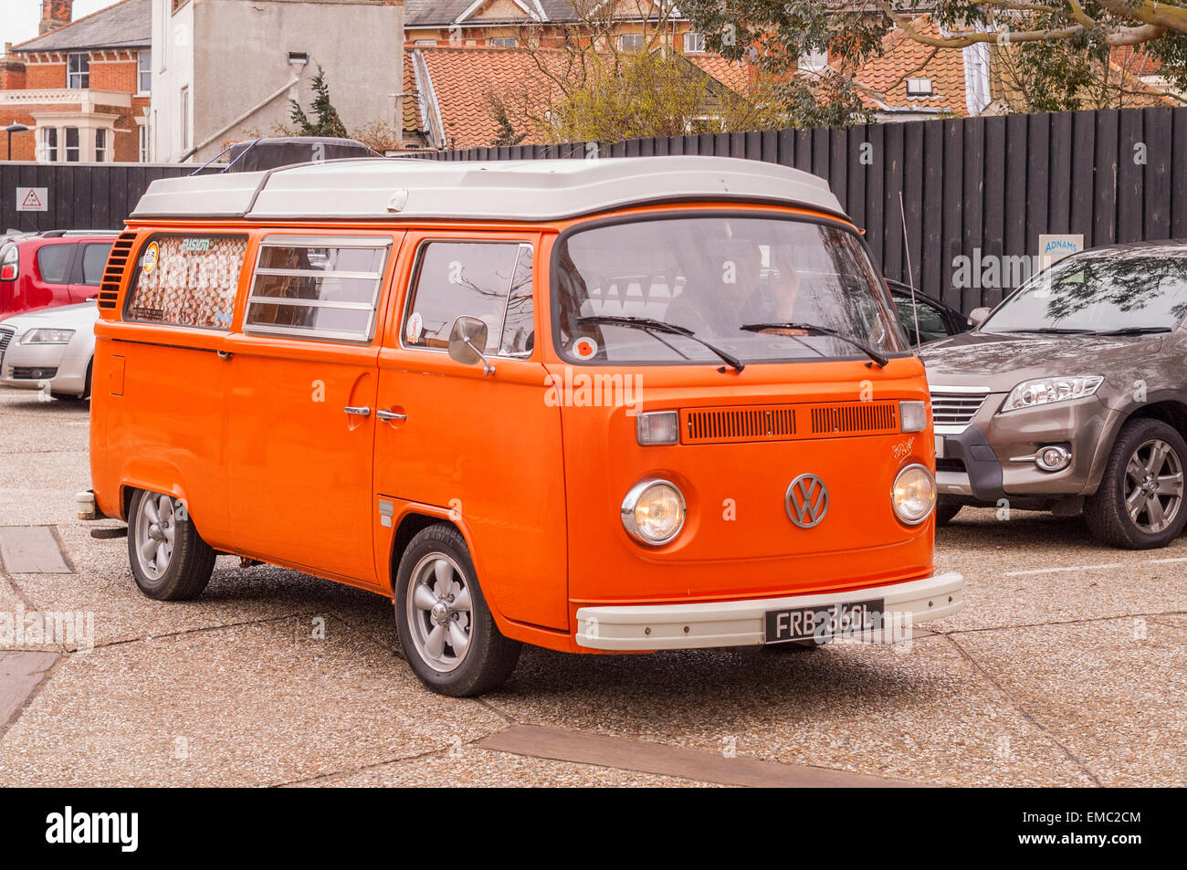 A classic VW campervan in orange in the Uk Stock Photo