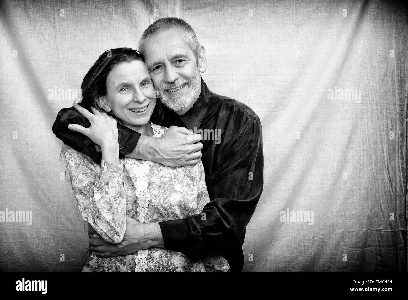 Happy mature man and woman smiling for S. Valentine's day or anniversary and embracing each other. Black and white photo. Stock Photo