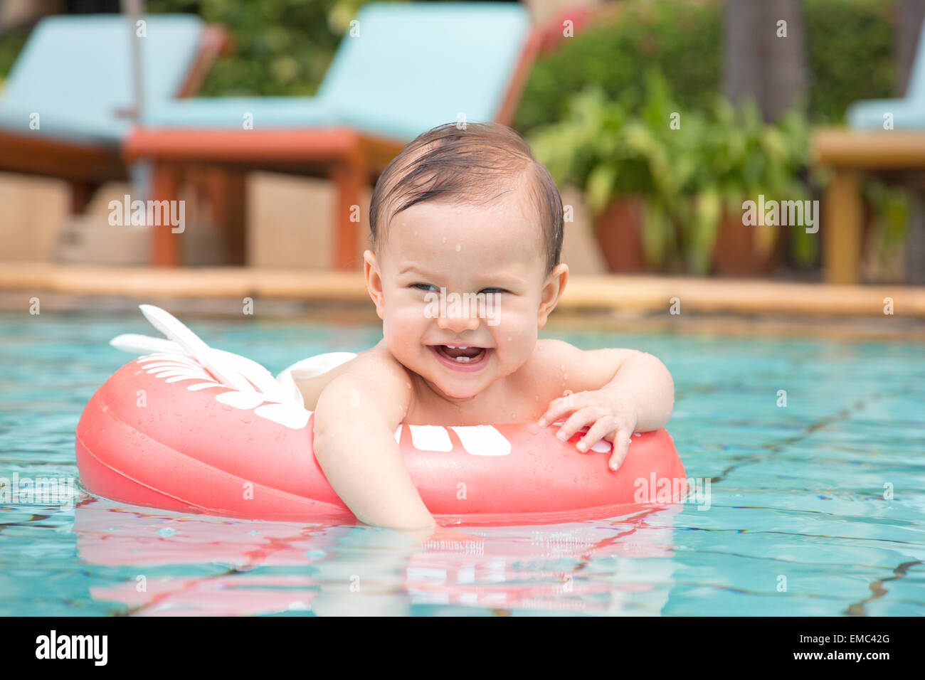 Thailand, happy baby girl with floating tire in swimming pool Stock Photo -  Alamy