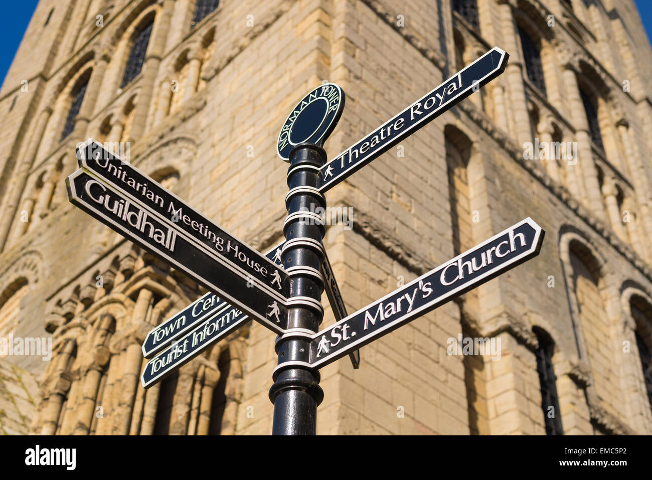 Bury St Edmunds attractions, view of a sign post beside the town's Norman tower directing visitors to several of Bury St Edmunds' attractions, Suffolk. Stock Photo