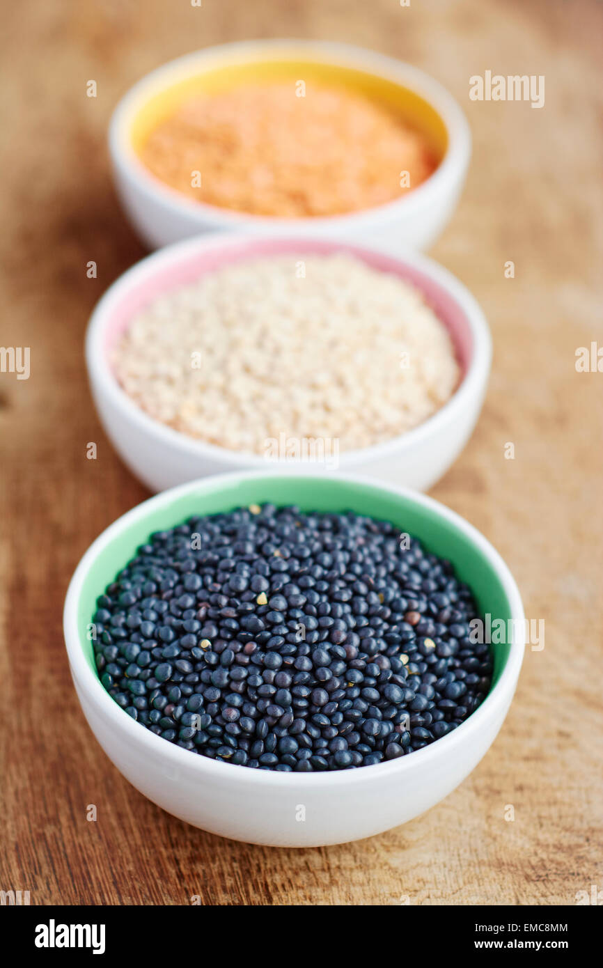 Three bowls of black, white and red lentils Stock Photo