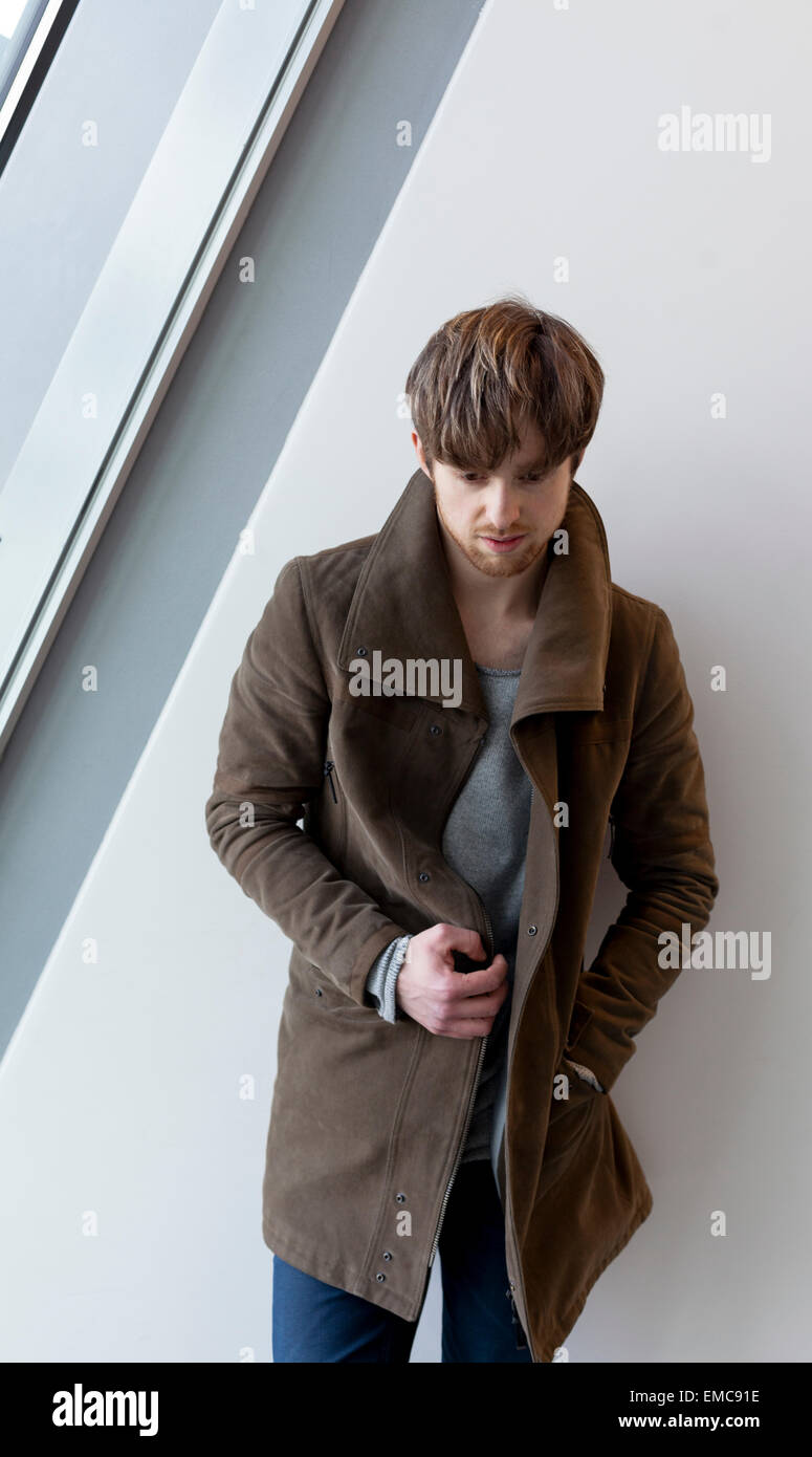 Portrait of stylisch young man wearing brown coat Stock Photo