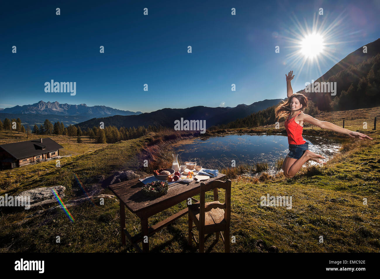 Austria, Altenmarkt-Zauchensee, young woman in the mountains at sunrise Stock Photo