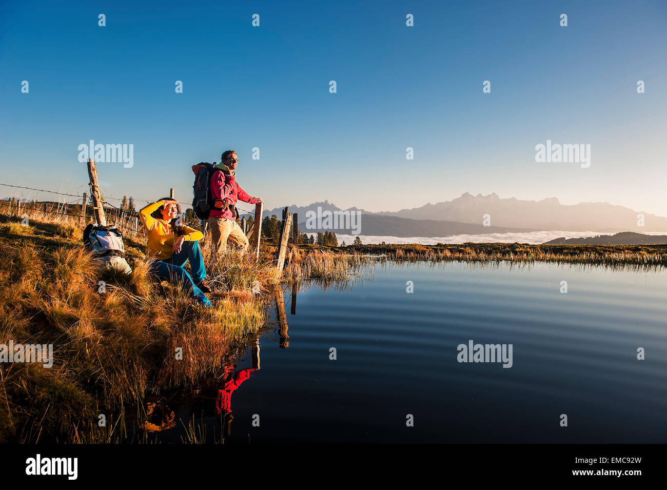 Austria, Altenmarkt-Zauchensee, young couple at mountain lake in the Lower Tauern Stock Photo