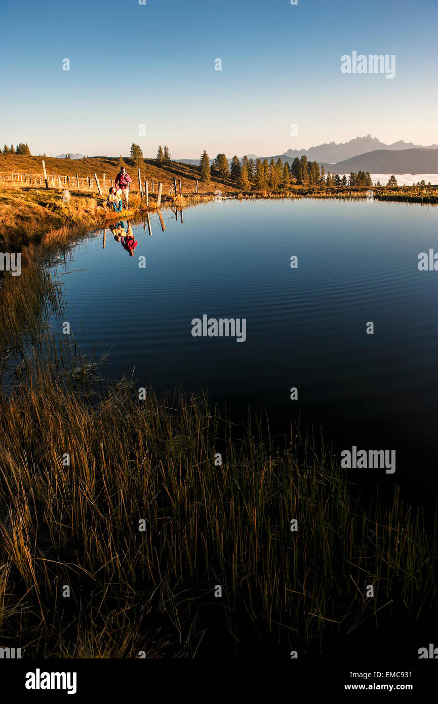 Austria, Altenmarkt-Zauchensee, young couple at mountain lake in the Lower Tauern Stock Photo