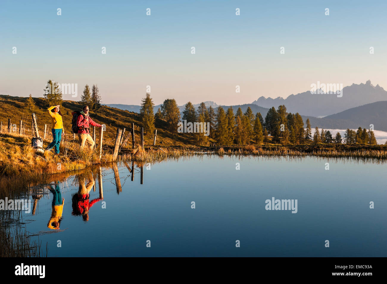 Austria, Altenmarkt-Zauchensee, young couple at mountain lake in the Lower Tauern Stock Photo