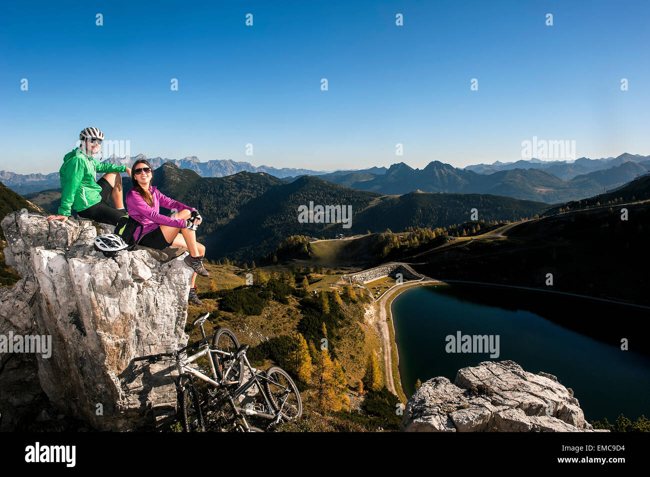 Austria, Altenmarkt-Zauchensee, young couple with mountain bikes in the mountains Stock Photo