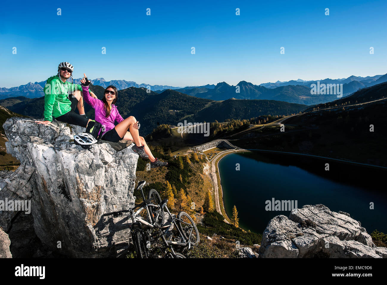 Austria, Altenmarkt-Zauchensee, young couple with mountain bikes in the mountains Stock Photo