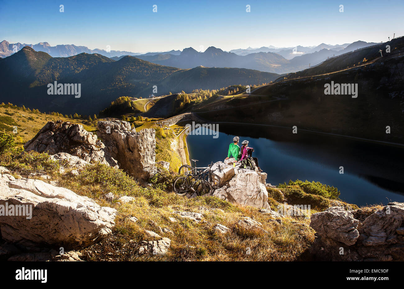 Austria, Altenmarkt-Zauchensee, young couple with mountain bikes in the mountains Stock Photo
