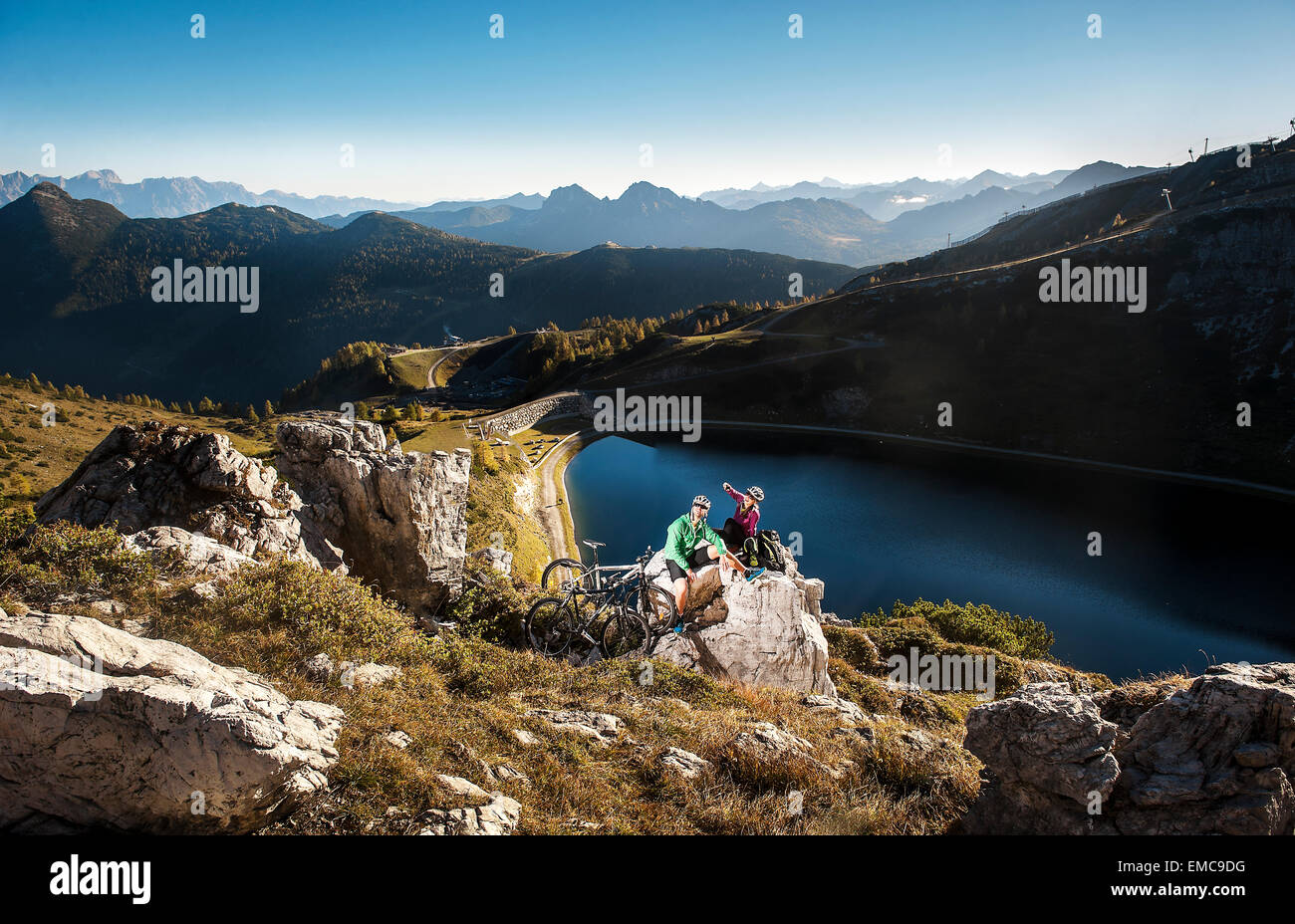 Austria, Altenmarkt-Zauchensee, young couple with mountain bikes in the mountains Stock Photo