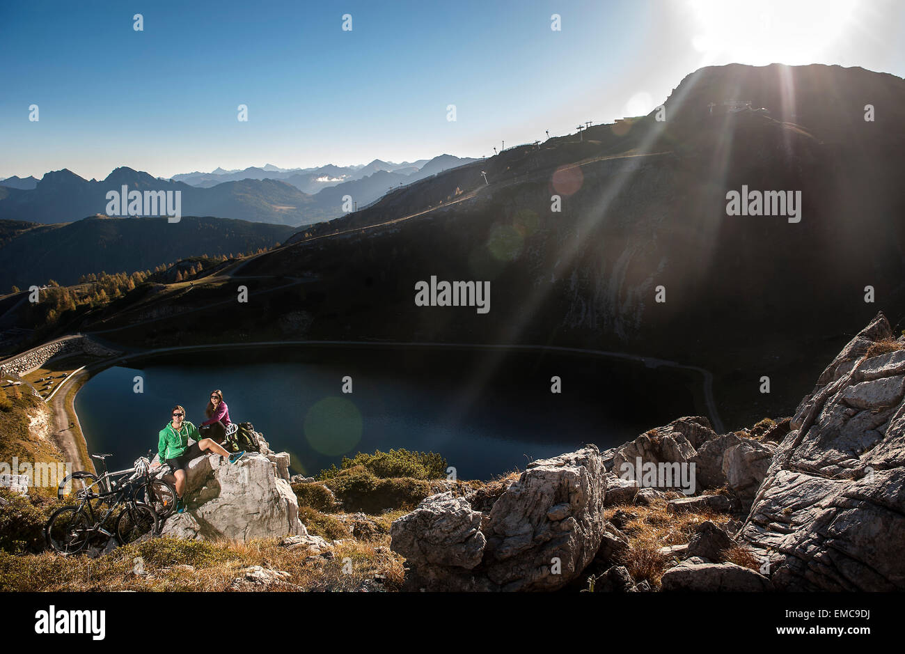 Austria, Altenmarkt-Zauchensee, young couple with mountain bikes in the mountains Stock Photo