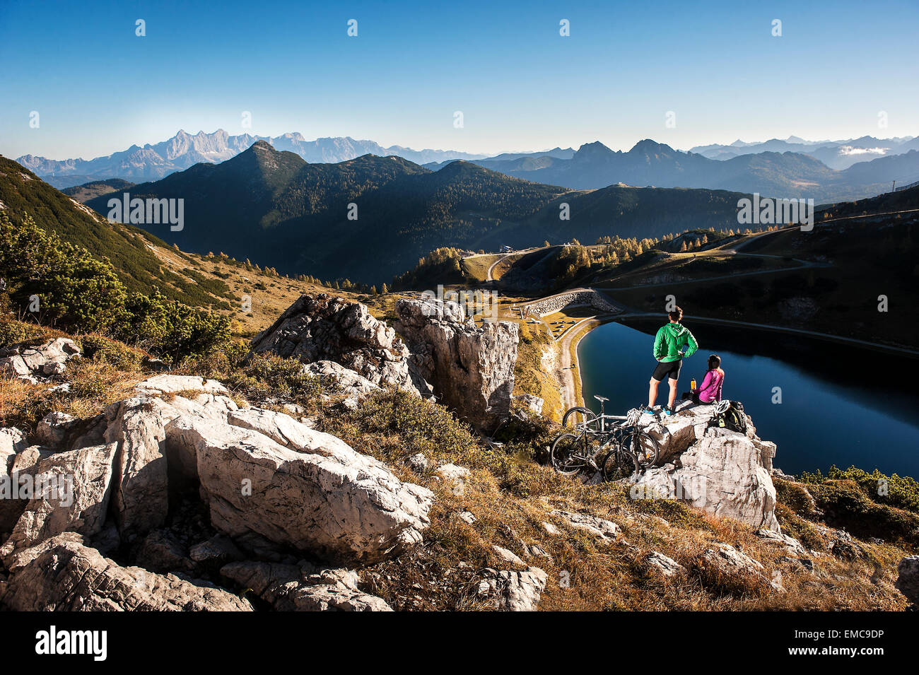 Austria, Altenmarkt-Zauchensee, young couple with mountain bikes in the mountains Stock Photo