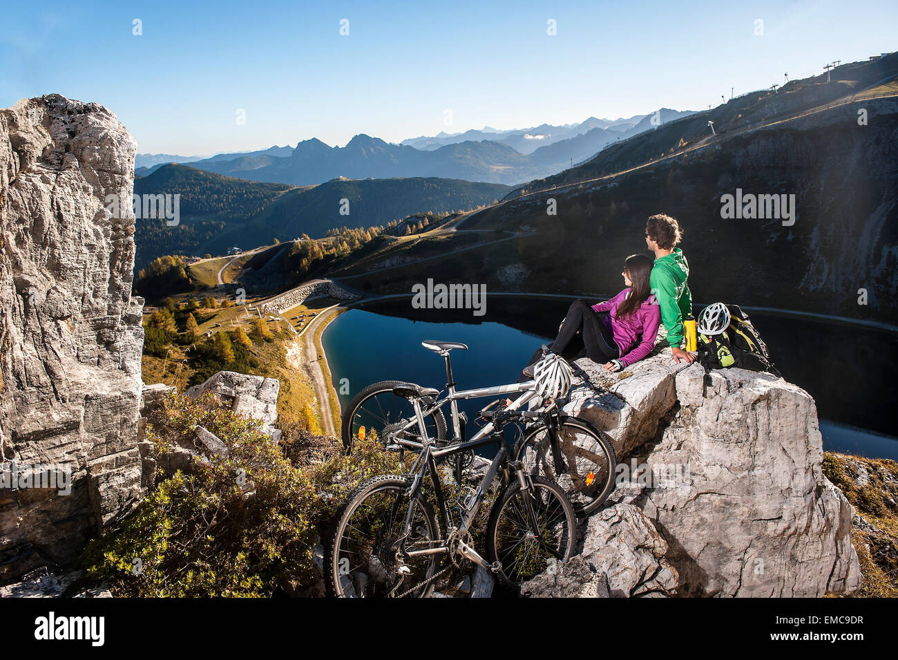 Austria, Altenmarkt-Zauchensee, young couple with mountain bikes in the mountains Stock Photo