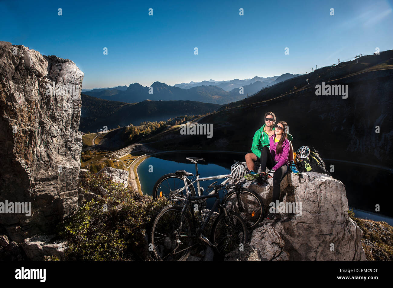 Austria, Altenmarkt-Zauchensee, young couple with mountain bikes in the mountains Stock Photo
