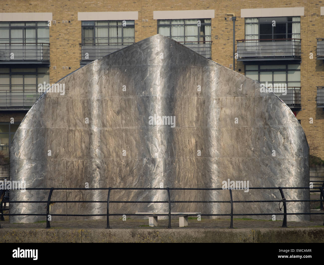 Liquidity by Simon Packard,stainless steel sculpture at Brentford Dock Marina on the River Thames, with railings in front,2002 Stock Photo