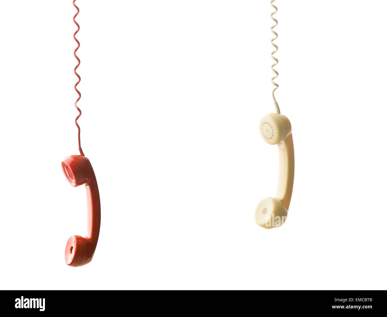 two different handsets from vintage phones hanging, on white background Stock Photo