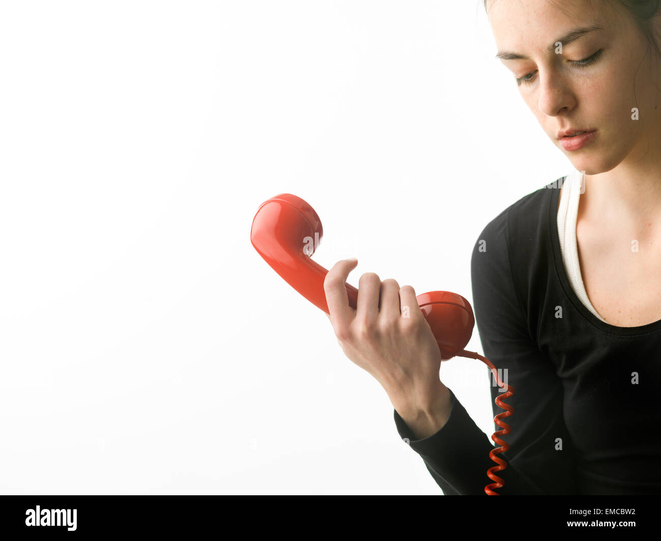 sad woman answering phone, on white background Stock Photo