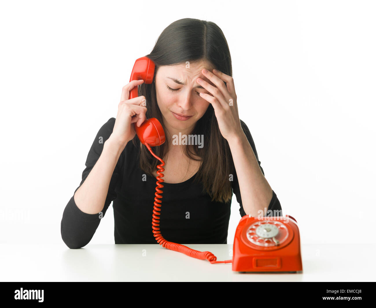 depressed woman talking on the phone, on white background Stock