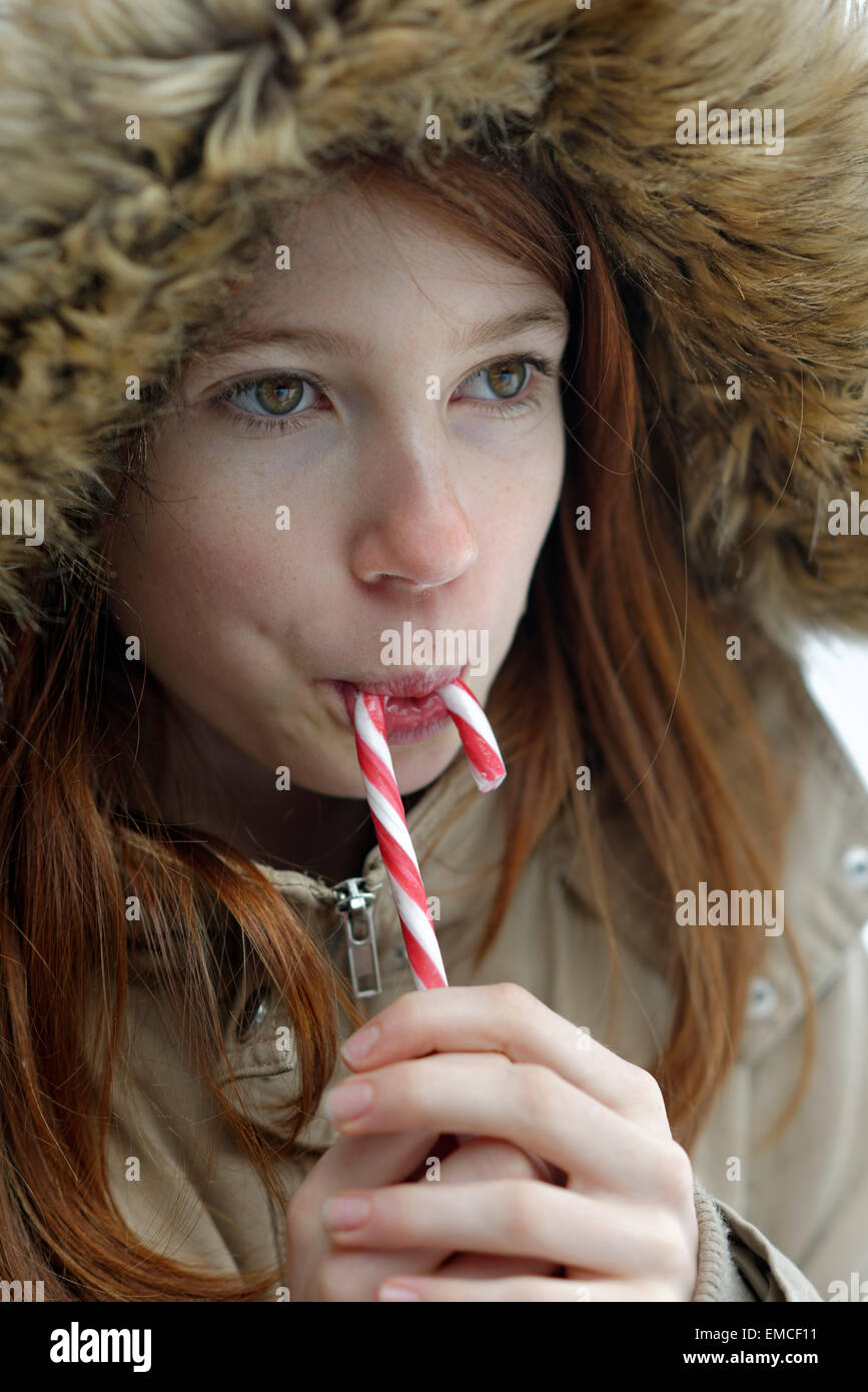 Girl enjoying candy cane Stock Photo Alamy