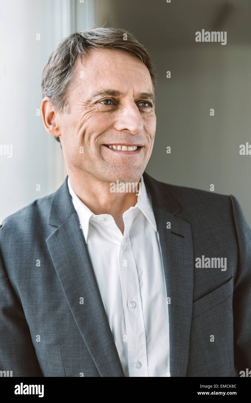 Portrait of smiling businessman Stock Photo - Alamy