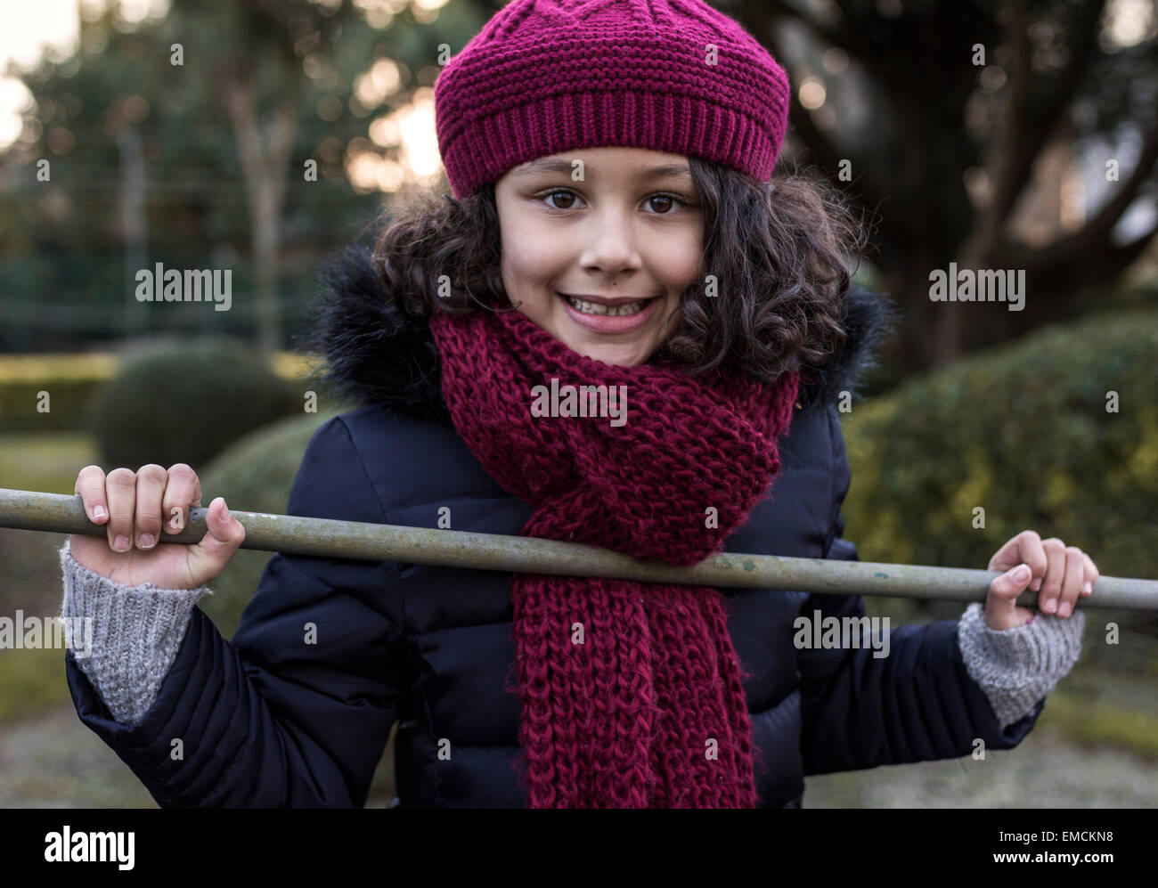 Portrait of smiling little girl wearing wool cap and scarf Stock Photo Alamy