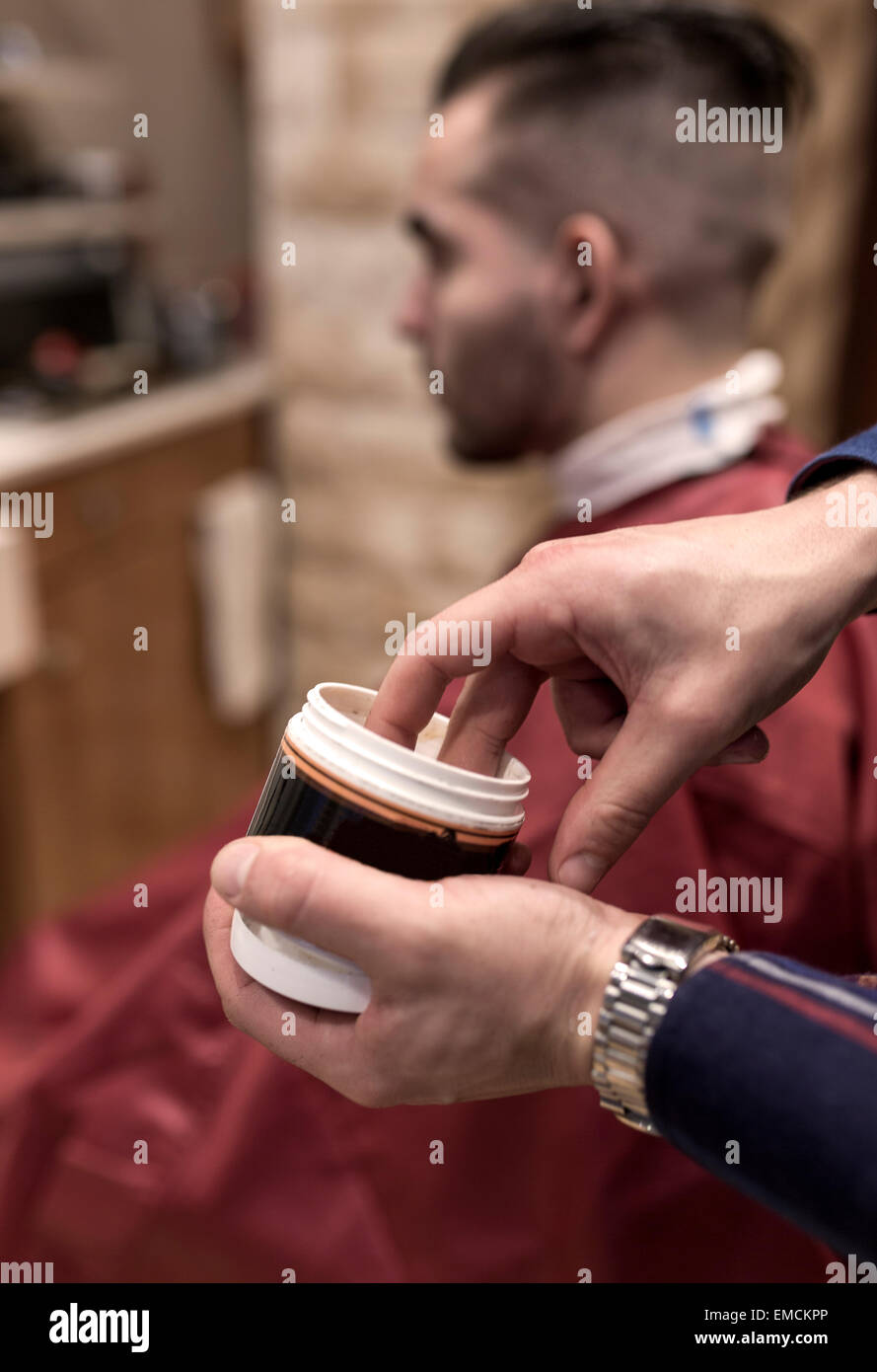 Hands of hairdresser holding pot of hair gel Stock Photo Alamy